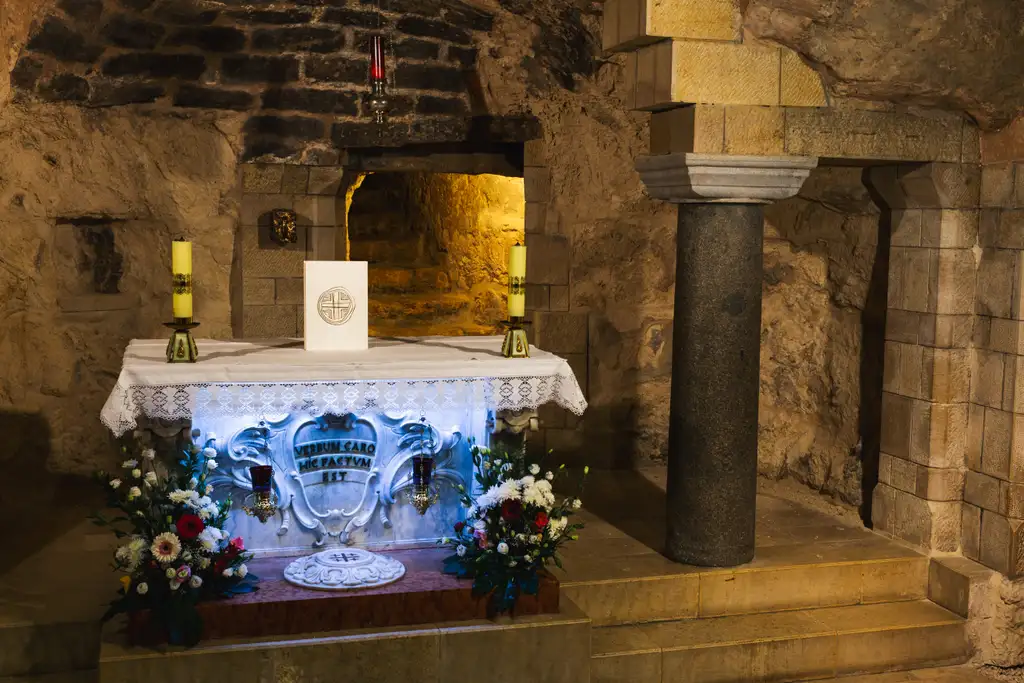 Tall candles burning beside the altar in the Grotto of the Annunciation.