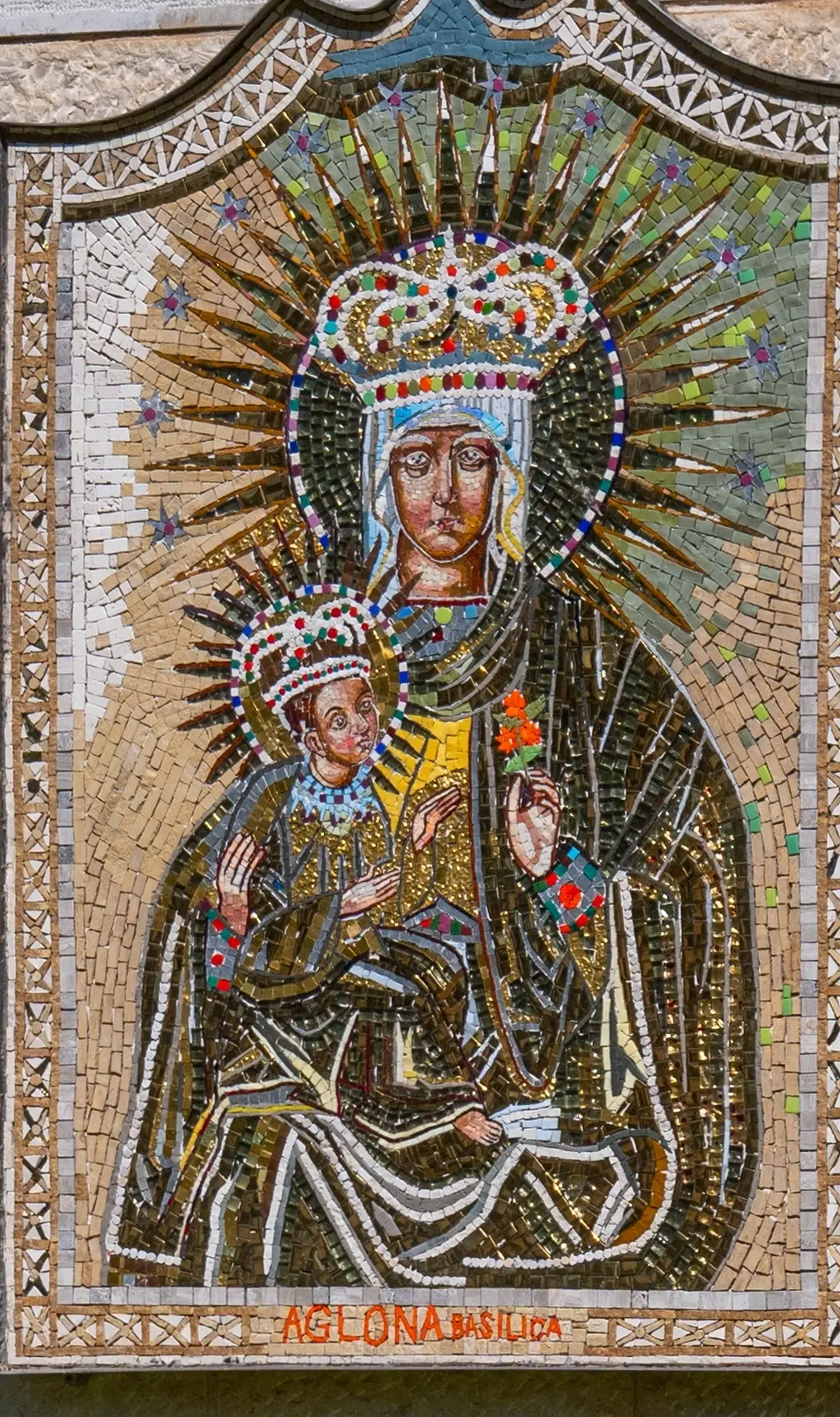 Mosaic of Our Lady of Aglona, donated by Latvia, on the basilica courtyard wall.