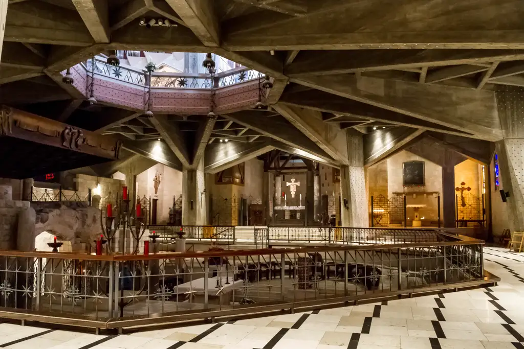 The upper church of the basilica, its concrete ribs vaulting over the open well above the Grotto.